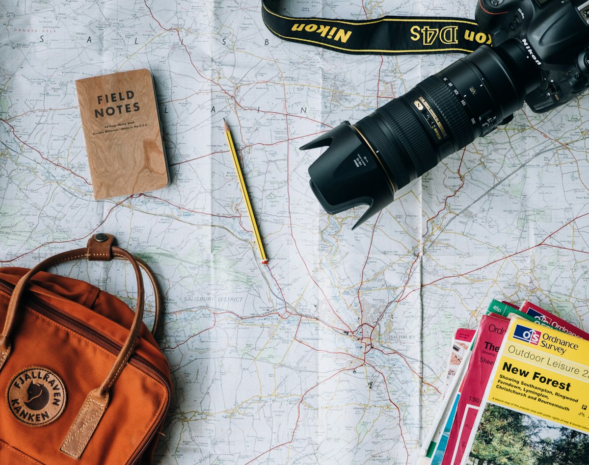 Map, notebook and camera laid out for a day of discovery